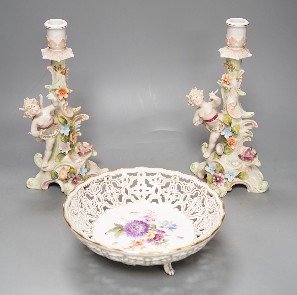 A Meissen flower painted pierced dish and two German porcelain candlesticks - 25.5cm tall